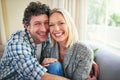 Happiest when were together. Cropped portrait of a mature couple sitting on their sofa at home. Royalty Free Stock Photo