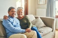 Happily married and in love. Portrait of an affectionate senior couple relaxing on a sofa together at home. Royalty Free Stock Photo