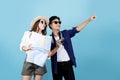 Happily smiling Asian tourist couple enjoying a summer vacation together on a bright blue background Royalty Free Stock Photo