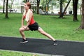 Happines Asian woman stretching her legs before run in park. Fitness and exercise concept.