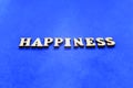 Happines white wooden letters on blue background