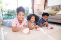 Happiness African family with children saving money in piggy bank for planning future of expense for financial success. Royalty Free Stock Photo