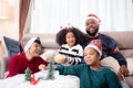 Happiness African family mom and dad and daughter watching tv and laughing with fun and enjoyment in the living room.