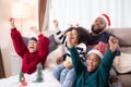 Happiness African family watching movie with excited and fun in the living room for leisure with comfort at home on Christmas day. Royalty Free Stock Photo