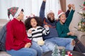 Happiness African family watching movie with excited and fun in the living room for leisure with comfort at home on Christmas day. Royalty Free Stock Photo