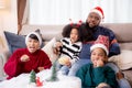 Happiness African family watching movie with excited and fun in the living room for leisure with comfort at home. Royalty Free Stock Photo