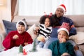 Happiness African family watching movie with excited and fun in the living room for leisure. Royalty Free Stock Photo