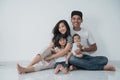Happiness asian family with two daughter sitting on the floor have fun Royalty Free Stock Photo