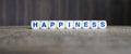 Happiness boggle word cubes on dark background