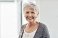 Happiness can never grow old. a senior woman smiling at the camera.