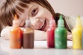Happiness of child. Little cute girl laughing and looking out for colored paints Royalty Free Stock Photo