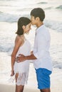 Happiness couple in romantic kissing scene on the beach at sunset. Love and valentine concept Royalty Free Stock Photo