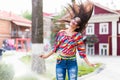 Happiness and craziness. Smiling funny girl have fun outdoor and dances. Young attractive woman with waving long hair Royalty Free Stock Photo