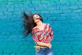 Happiness and craziness. Smiling funny girl have fun outdoor and dances. Young attractive woman with waving long hair Royalty Free Stock Photo