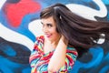 Happiness and craziness. Smiling funny girl have fun outdoor and dances. Young attractive woman with waving long hair Royalty Free Stock Photo