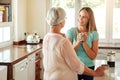 Happiness is a cup of coffee and a good chat. an affectionate mother and daughter spending time together at home. Royalty Free Stock Photo