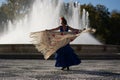 The happy woman dancing and having fun near the fountain Royalty Free Stock Photo