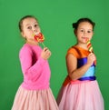 Happiness and dessert concept. Children eat big colorful sweet caramels. Royalty Free Stock Photo