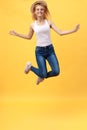 Happiness, dream, fun, joy, summer concept. Very excited happy cute caucasian teen is jumping up, in summer outfit, hat