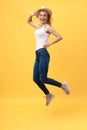 Happiness, dream, fun, joy, summer concept. Very excited happy cute caucasian teen is jumping up, in summer outfit, hat Royalty Free Stock Photo