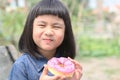 Happiness face of asian children with sweet donut in hand