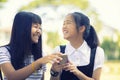 Happiness face of asian teenager holding smart phone in hand with toothy smiling face Royalty Free Stock Photo