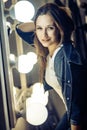 Happiness freckled girl in theatre dressing room, sitting near m Royalty Free Stock Photo