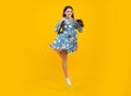 Happiness, freedom, motion and child. Young teenager girl jumping over yellow background, funny jump. Excited face Royalty Free Stock Photo