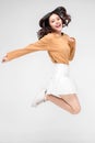 Happiness, freedom, motion and people concept - smiling young woman jumping in air over gray background Royalty Free Stock Photo