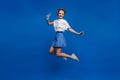 Happiness, freedom, motion and people concept - smiling young woman jumping in air over white background Royalty Free Stock Photo