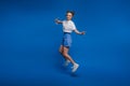 Happiness, freedom, motion and people concept - smiling young woman jumping in air over white background Royalty Free Stock Photo