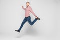 Happiness, freedom, movement and people concept - smiling young man jumping in air isolated on white Royalty Free Stock Photo