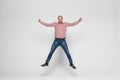 Happiness, freedom, movement and people concept - smiling young man jumping in air isolated on white background Royalty Free Stock Photo