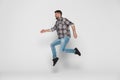 Happiness, freedom, movement and people concept. Smiling young man jumping in air isolated on white background Royalty Free Stock Photo