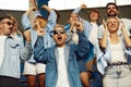 Happiness. Group of sport fans, enthusiasts, people cheering up favourite team during football match Royalty Free Stock Photo