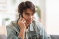 Happiness handsome asian young man smiling talking with girlfriend on mobile phone at home. Attractive charming teenager holds Royalty Free Stock Photo