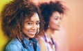 Happiness is hanging out with a friend. Portrait of an attractive young woman posing with her friend against a colorful Royalty Free Stock Photo