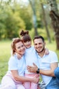 Happiness and harmony in family life. Happy family concept. Young mother and father with their daughter in the park. Happy family Royalty Free Stock Photo