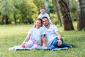 Happiness and harmony in family life. Happy family concept. Young mother and father with their daughter in the park Royalty Free Stock Photo