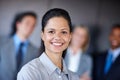 Happiness is an inside job. a confident businesswoman standing in front of her team at the office. Royalty Free Stock Photo