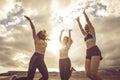 Happiness and joy for sport success active lifestyle - group of pretty females friends jumping on the air together for victory -