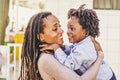 Happiness and joyful black race african family concept with mother and son together having fun and laughing a lot - hug and love