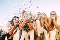 Happiness and joyful concept - group of happy women people celebrate. all together blowing confetti and having fun - new year eve