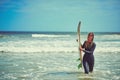 For happiness just add water and waves. a beautiful young woman going for a surf at the beach. Royalty Free Stock Photo