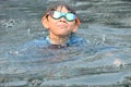 happiness little boy swimming in the pool on summertime