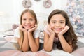 Happiness lives here. Happy children smile on bed. Small girls enjoy happiness on xmas eve. Childhood happiness Royalty Free Stock Photo