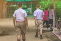 Happiness male students walk behind his girlfriends