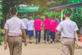 Happiness male students walk behind his girlfriends