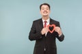 Happiness man holding small red heart and looking at camera Royalty Free Stock Photo