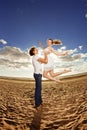 Happiness man holding a woman on the beach. Couples in love by a